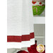 A super close up on the bottom of the towel, showing details on the towel texture and the fabric stripe.