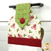 An angled close up on the top of the towel, demonstrating fabric colors on the prints and fabric button.