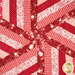 A super close up on the center of the topper, showing mesmerizing details on the spiral of precise patchwork.