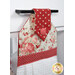 An angled super close up on the top of the towel, demonstrating fabric colors on the prints and fabric button.