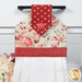 A super close up on the top of the towel, demonstrating fabric colors on the prints and fabric button.