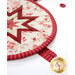 A super close up on the round hot pad, demonstrating details on the binding, fabric loop, and folded points.