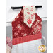 An angled super close up on the top of the towel, demonstrating fabric colors on the prints and fabric button.