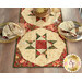 A closer look at one of the blocks of the runner, showing details on the patchwork blocks and staged with two coordinating table settings.