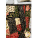 A close up on the patchwork of the bag kit, showing details on the fabric colors, prints, and gold metallic flourishes.