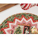 A stylized close up on the edge of the topper, showing print and color details on the fabrics; a coordinating mug peeks into from from the top left.