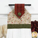 A super close up on the top of the towel, demonstrating fabric colors on the prints and fabric button.