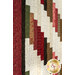 A close up on the patchwork of the quilt, demonstrating fabric colors and print details.