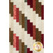 A close up on the patchwork of the quilt, demonstrating fabric colors and print details.