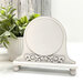The fully assembled and painted Fleur Mini Round Cross Stitch Frame, staged on a white tabletop.