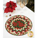 The completed topper, colored in red, cream, and green metallic fabrics from the Poinsettias at Christmas collection from Riley Blake Fabrics, staged on a white table with coordinating glassware and décor.