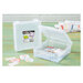 Image of two ArtBin 6" x 6" storage boxes, one open and one closed staged on a green table with stickers and books.