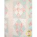 A super close up on the quilt, showing details on the fabric colors, prints, and top quilting details.