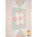 A super close up on the quilt, showing details on the fabric colors, prints, and top quilting details.