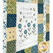 A close up on the quilt, showing details on a panel block that says "A friend is a great blessing."