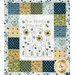 A close up on the quilt, showing details on a panel block that says "True friends bring great joy."