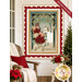 The completed Christmas Greetings Panel Quilt, colored in cream, green, red, pink, and blue fabrics from the Christmas Greetings collection by Riley Blake Designs,  staged on a white porch wall with coordinating décor. A red banner at the top reads "Backing Included!"