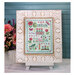 A decorative framed cross stitch project featuring the words "Gratitude is the secret to a full life" with florals, hearts, birds, butterflies, and dragonflies.