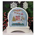 The finished Winter Joy cross stitch project featuring snow globe design with a brick house with a snowman in the yard and Santa flying his sleigh above, framed with decorative trim and displayed on a wooden snow globe frame.