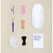 Contents of the kit featuring acrylic yarn balls, a crochet hook, a needle, and stuffing.
