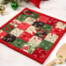 An angled shot of the finished hot pad, showing details on the Christmas fabrics. Coordinating utensils and décor peek into frame from either side.