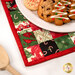A close up on the hot pad, staged with a plate of holiday cookies, showing details on the fabrics and binding.