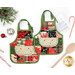 Two festive apron hot pads colored in fabrics from the Holiday Cheer collection by Moda Fabrics,, staged on a clean white table with coordinating décor, a wooden spoon, and a recipe card.