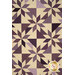 A close-up on the patchwork of the quilt, demonstrating fabric prints, colors, and layout details.