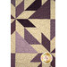 A super close up on the quilt, showing fabric and top quilting details.