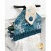 An angled close up on the top of the towel, demonstrating fabric colors on the prints and fabric button.
