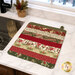 The completed Dry Ideas project, colored in cream, red, green, and black fabrics from the Candlelight Christmas collection by Moda Fabrics, staged on a white marble kitchen counter with coordinating decor.