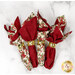 The four completed cloth napkins, colored in cream, red, green, and black fabrics from the Candlelight Christmas collection by Moda Fabrics, staged on a white marbled counter.