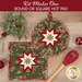 The two completed Folded Star Hot Pads colored in cream, red, and green fabrics from the Candlelight Christmas collection by Moda Fabrics, slightly overlapping each other and staged on a wood table with coordinating décor.
