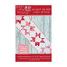 The front of the red and pink Starlet Hearts Table Runner Pattern, showing the finished table runner on a chipped paint wooden table.