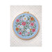 Cross-stitch pattern of a colorful bunch of wildflowers framed in a circular hoop against a multicolor dotted background.