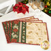 The four completed placemats, colored in cream, green, and red fabrics from the Poinsettias at Christmas collection by Jennifer Bosworth for Riley Blake Designs, staged on a white table with coordinating flowers and wine glasses; a decorated Christmas tree peeks into frame from the upper right corner.