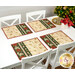 The four completed placemats, staged on a white table beside coordinating tableware and a decorated tree.