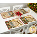 The four completed placemats, staged on a white table with coordinating plates, glasses, and silverware beside a decorated tree.