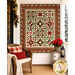 The completed Poinsettias at Christmas Patchwork BOM, colored in cream, green, and red fabrics from the Poinsettias at Christmas collection by Jennifer Bosworth for Riley Blake Designs, hung on a white porch on a snowy day, staged with coordinating décor.
