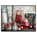Finished Country Santa cross stitch pattern in a vintage home scene next to porcelain Christmas antiques.