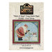 Front cover of the Good Tidings pattern by Teresa Kogut, with a red cross stitch border surrounding Santa and a snowman decorating a baby Christmas tree.