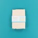 The blank apron in its packaging and isolated on a blue background. 