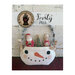 Finished Frosty Pals dolls inside of the Snowman bucket on a red carpet and against a textured white wall.