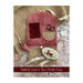 Faithful, Kind, & True needle keep next to other stitching and quilting projects on a taupe fabric.