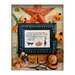 Finished Witches Lean pattern in a detailed black frame surrounded by Halloween motifs and scissors on a wooden plank backdrop.