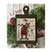 Finished S. Claus pattern with Santa holding an assortment of gifts on a dolly pulled by a snowman.