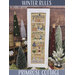 Framed “Winter Rules” cross-stitch pattern displayed among holiday decorations.