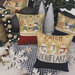 Decorative pillows with holiday sayings on a checkered tablecloth, surrounded by winter decor.