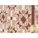 A close up on the patchwork of the quilt, demonstrating fabric colors and print details.
