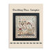Finished Dwelling Place Sampler with florals, birds, and animals surrounding a manor bordered by vines and stars inside of a black frame.